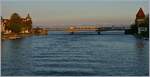 Zwei SBB RABe 521 sind als  Seehas  auf der Rheinbrücke in Konstanz unterwegs im Hintergrund die Alpen im Abendlicht.